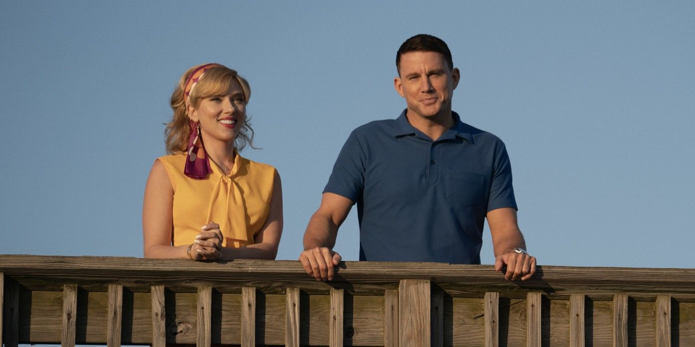 Scarlett Johansson and Channing Tatum standing side by side at the railing of a boardwalk in Fly Me to the Moon