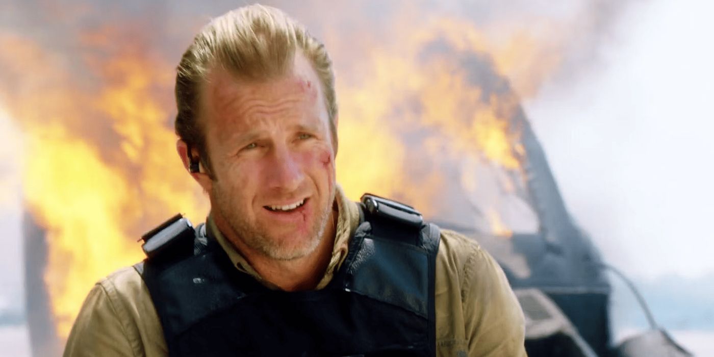 Scott Caan as anny with a volcano erupting behind him