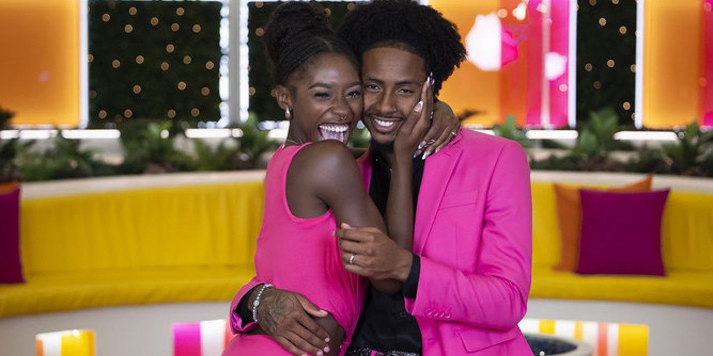 Serena Page & Kordell Beckham from Love Island USA Season 6 posing in matching pink outfits in front of a yellow couch.