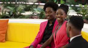 Serena Page & Kordell Beckhamfrom Love Island USA Season 6 smiling on a couch in matching pink outfits.