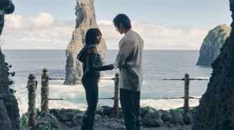 Qimir (Manny Jacinto) and Osha (Amandla Stenberg) standing in front of the water on the Unknown Planet in The Acolyte season 1 episode 6
