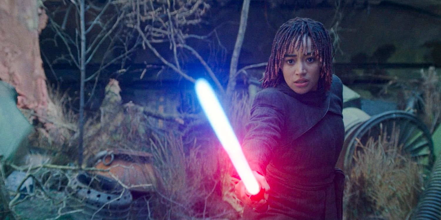 Osha (Amandla Stenberg) holding Master Sol's lightsaber, which begins to glow red in The Acolyte season 1 episode 8