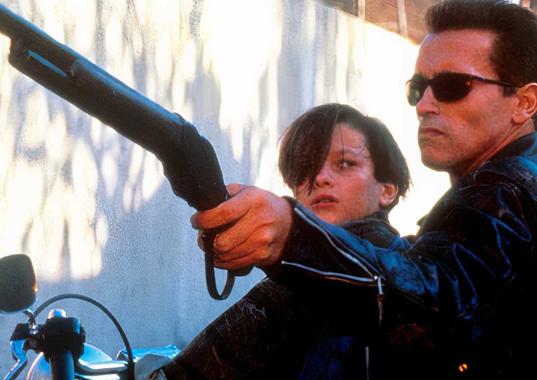 The terminator on the back of a motorcycle with John in Terminator 2