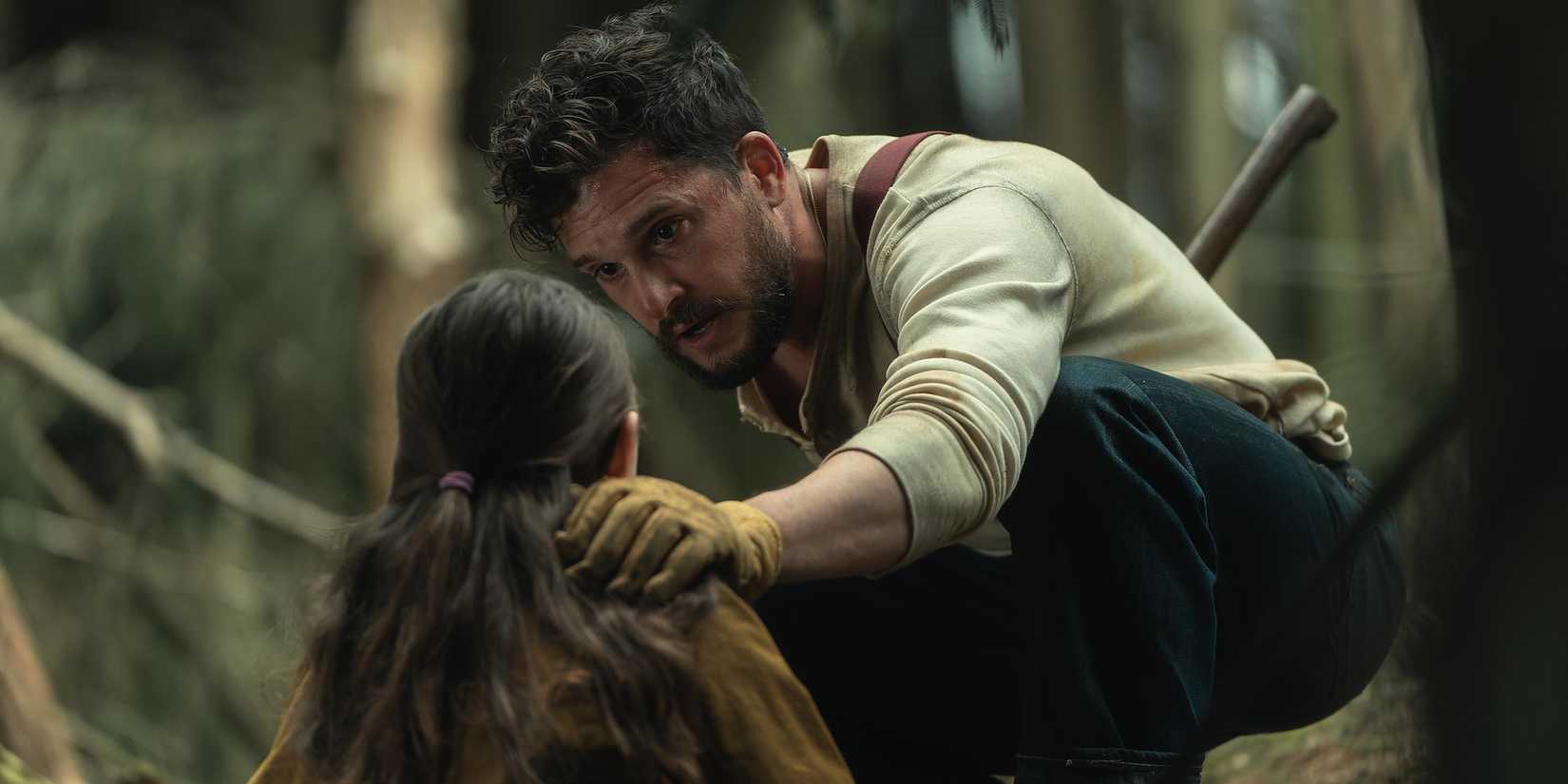 Kit Harington comforts a young child and speaks urgently to them in The Beast Within