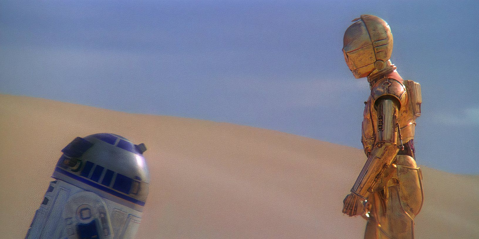 R2-D2 and C-3PO standing in the desert on Tatooine in A New Hope