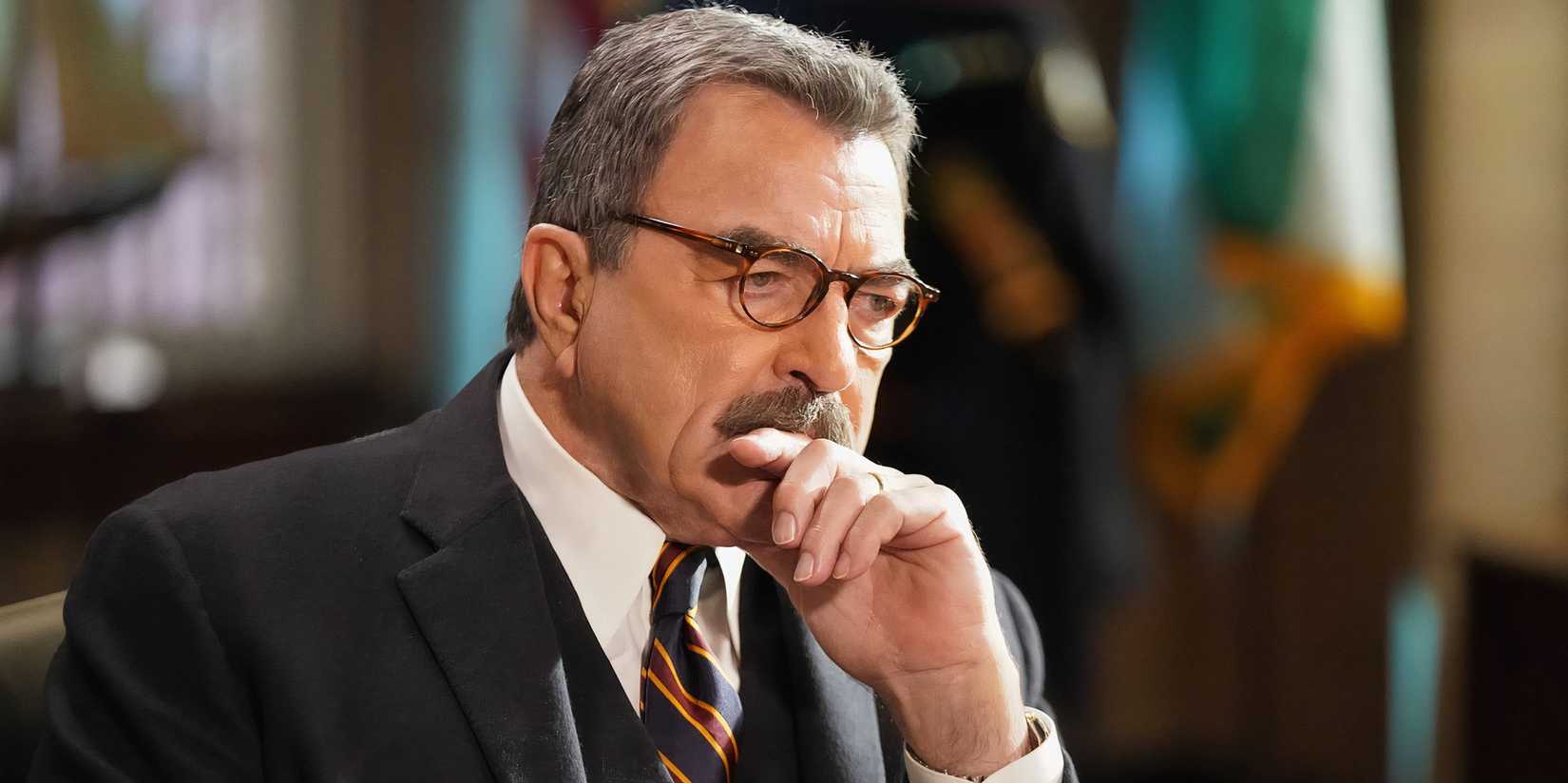Tom Selleck's Frank Reagan resting his hand on his chin in Blue Bloods