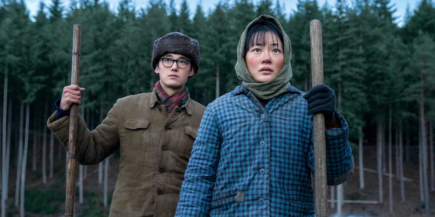 Yang Hewen as Bai Mulin, Zine Tseng as Young Ye Wenjie stand outside a forest in episode 101 of 3 Body Problem