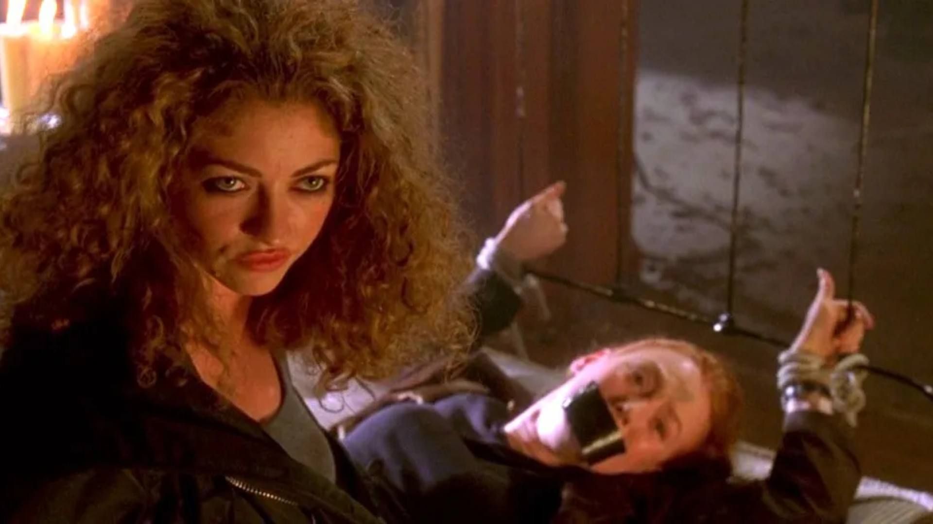 A woman looks on with another tied up in Urban Legend