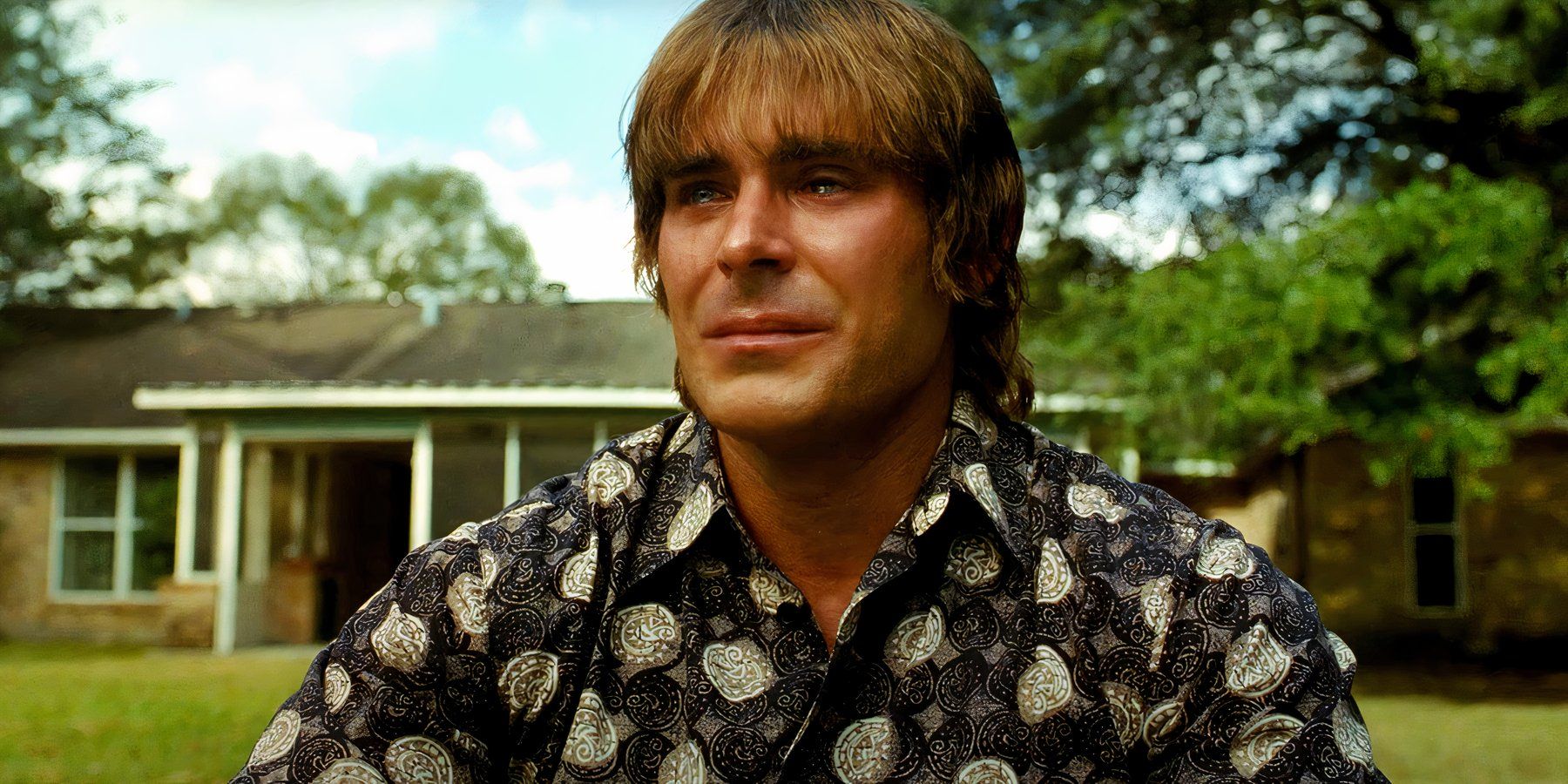 Zac Efron as Kevin von Erich crying while watching his boys play in The Iron Claw