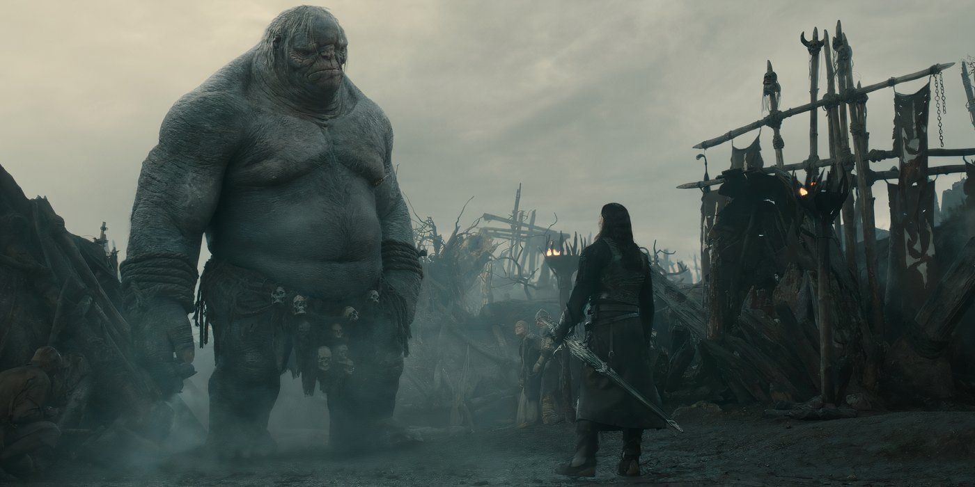 Adar standing in front of a giant troll in the trenches of Mordor in Rings of Power season 2