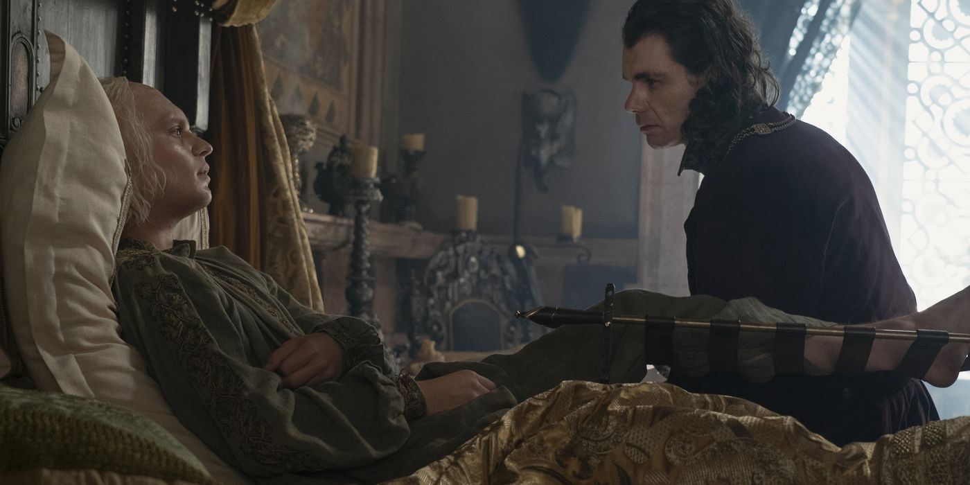 Aegon lies in bed, grievously wounded, while Lord Larys Strong sits at his side and counsels him in House of the Dragon