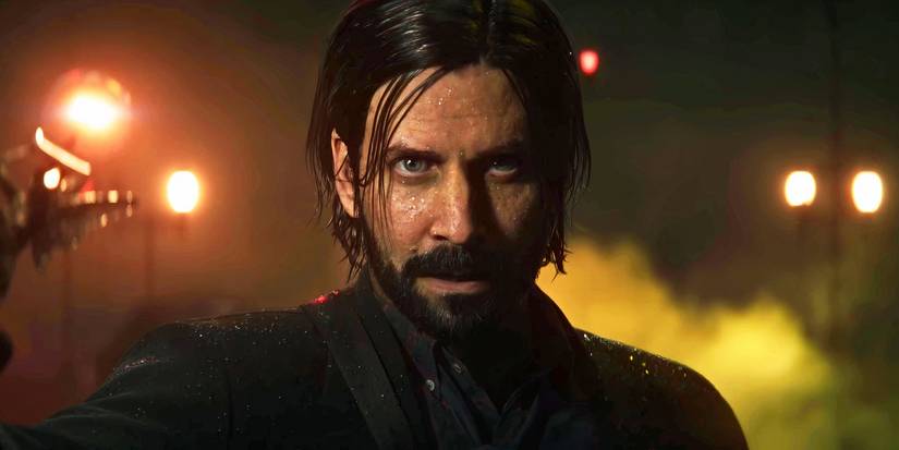 Alan Wake sosteniendo una luz en la oscuridad en Alan Wake 2.