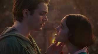Andrew Burnap as Jonathan holding Rachel Zegler's Snow White's face in Snow White