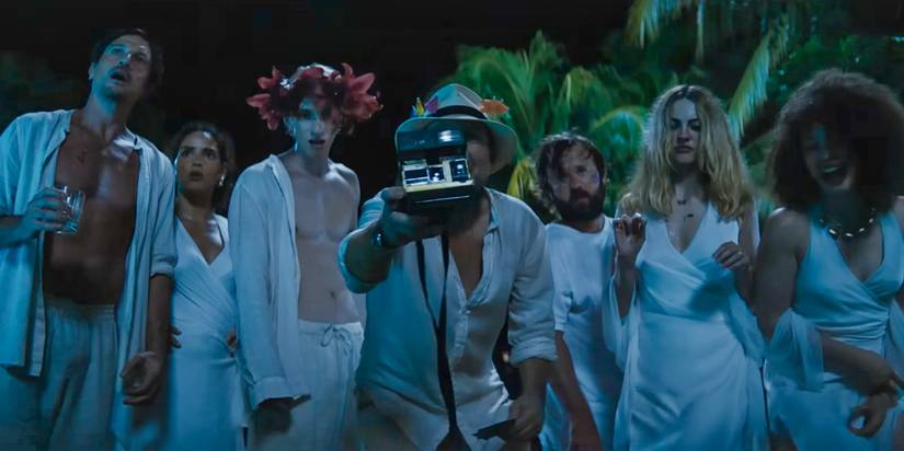 All the characters wearing white outfits and taking an instant photo in Blink Twice (2024)