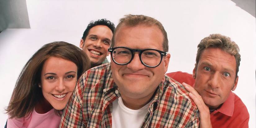 Cast Of The Drew Carey Show smiling together.