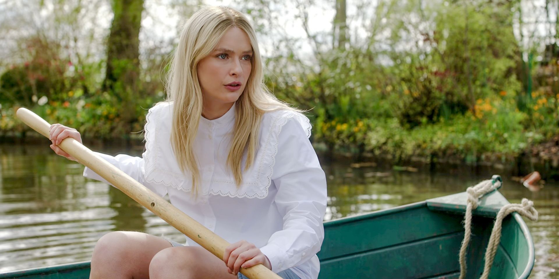 Camille (Camille Razat) in a boat as a volunteer at Claude Monet's house in Emily in Paris Season 4