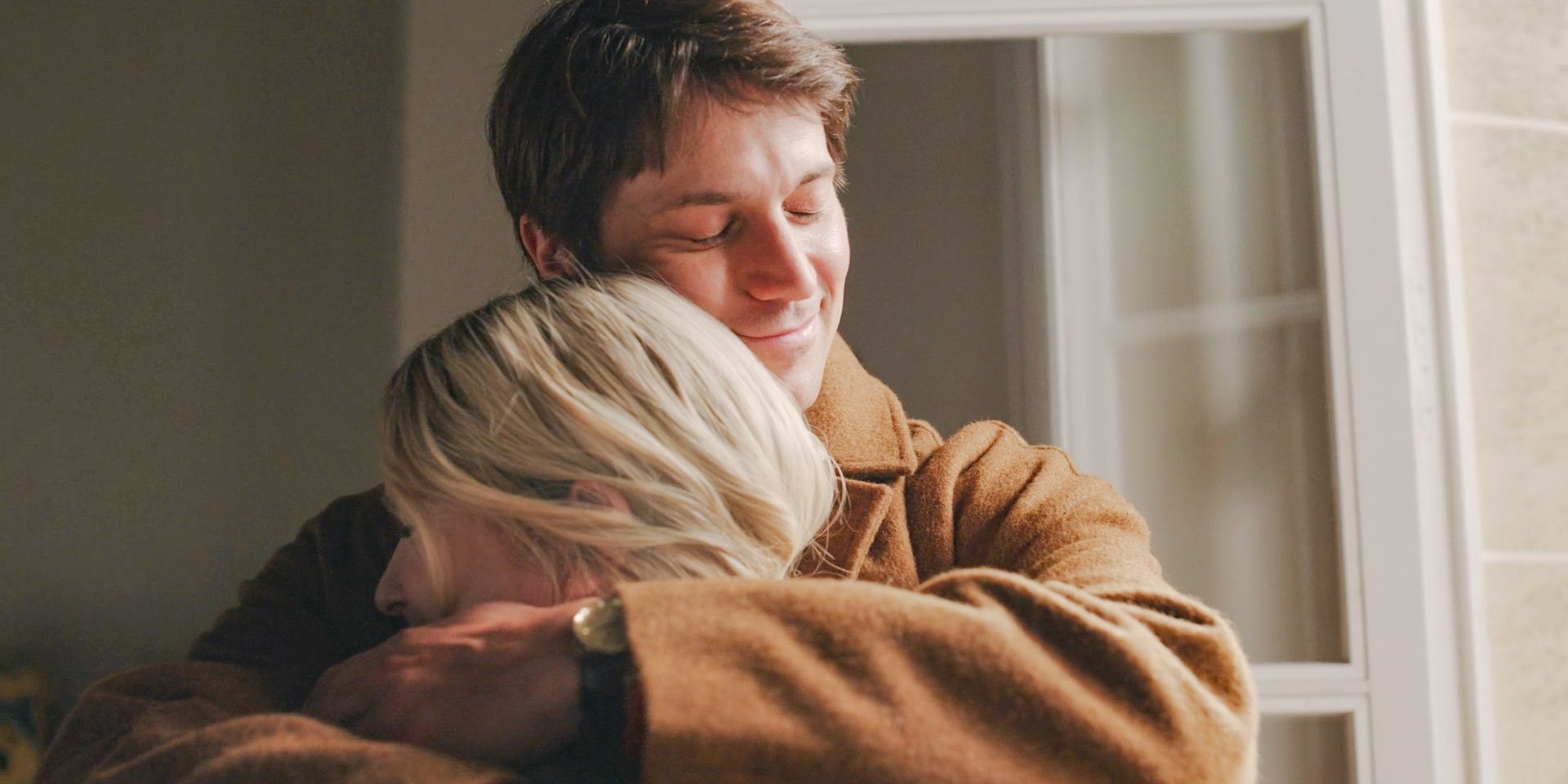 Gabriel (Lucas Bravo) hugs Camille happily because they are going to be parents in Emily in Paris Season 4