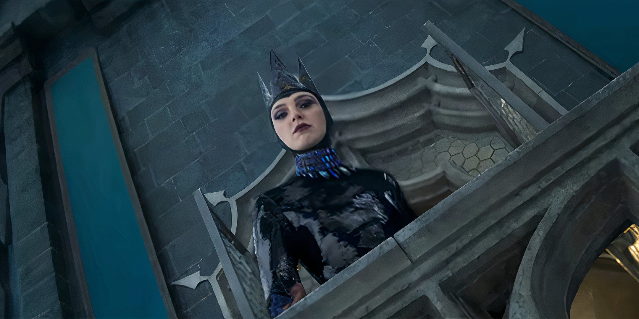 Gal Gadot as the Evil Queen looking down angrily from a balcony in Snow White