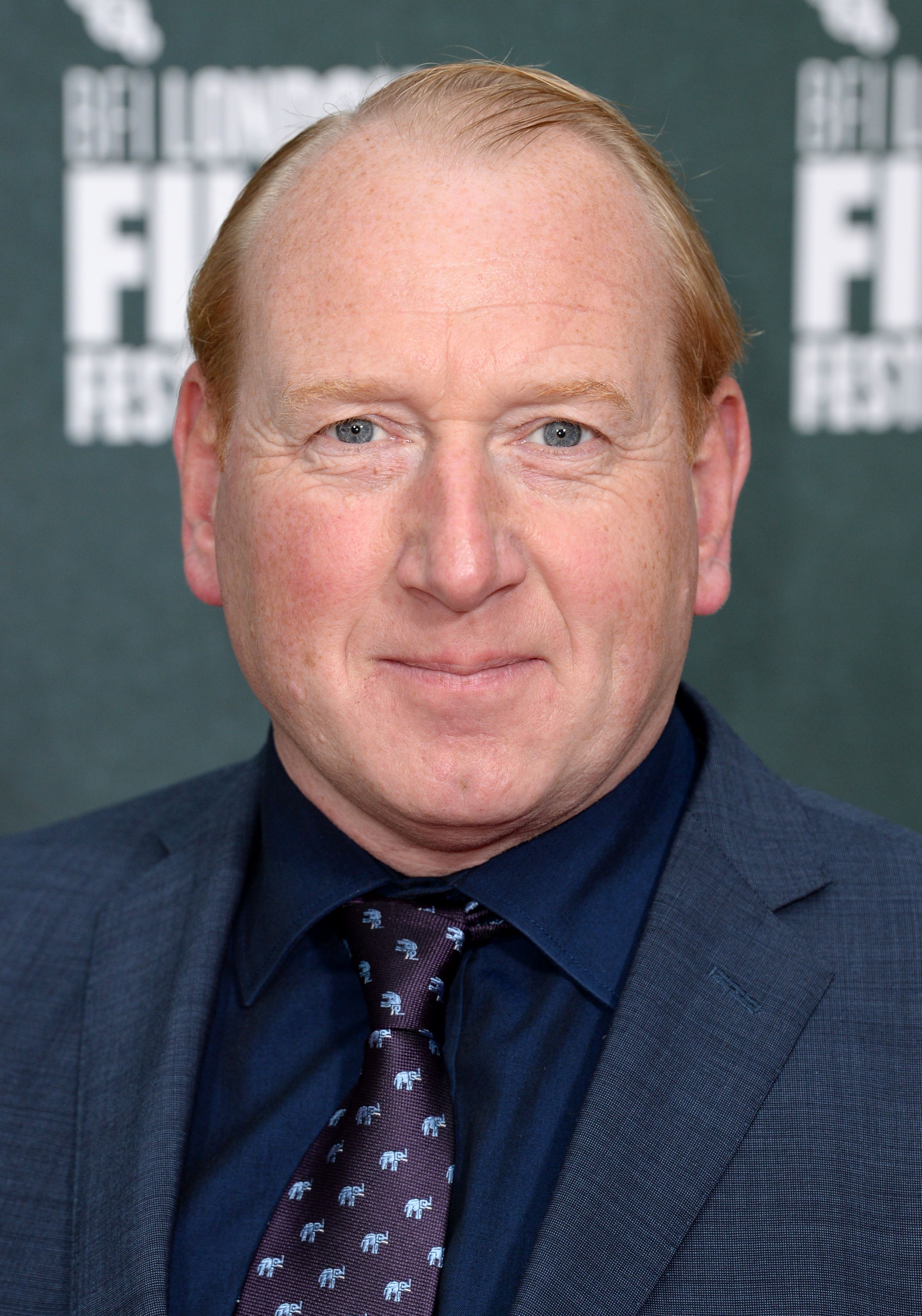 Headshot Of Adrian Scarborough