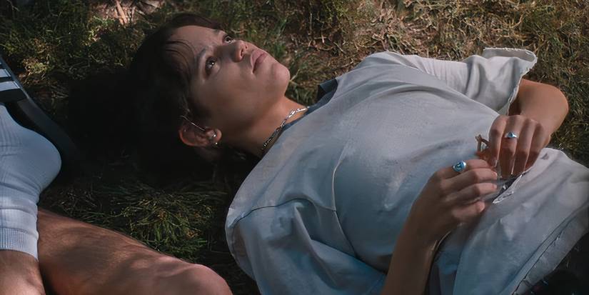 jenna ortega lying in the grass in the fallout