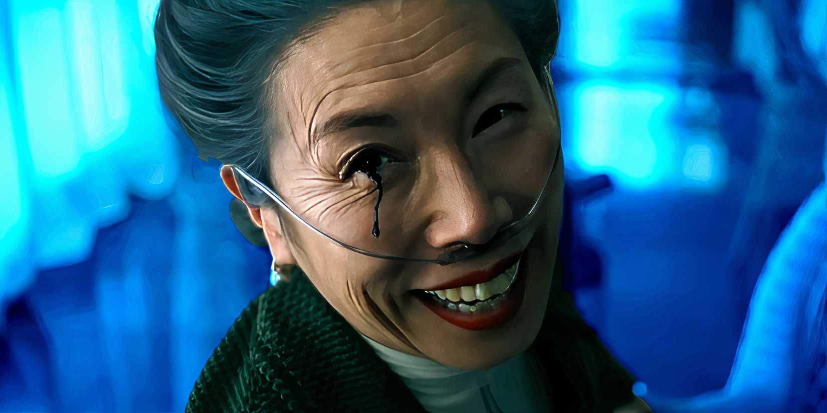 Jodi Long as Lucy smiling creepily with black water coming out of her eye in Night Swim