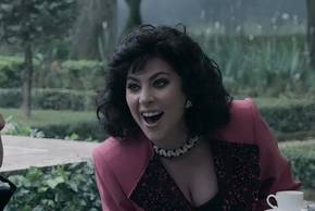 Lady Gaga as Patrizia laughing at a table in House of Gucci