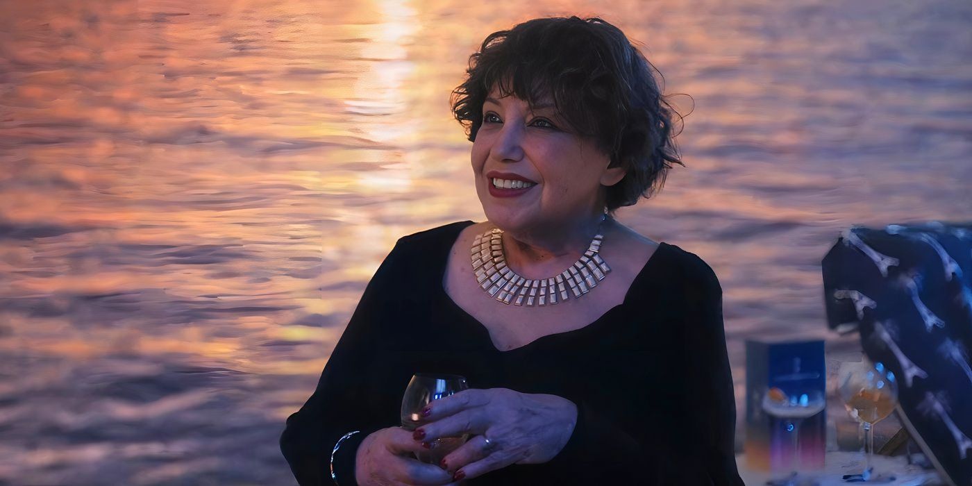 Liliane Rovère as Heloise at the nightclub smiling at Laurent in Emily in Paris