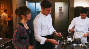 Lily Collins as Emily talks as Lucas Bravo as Gabriel cooks in Emily in Paris season 3-1