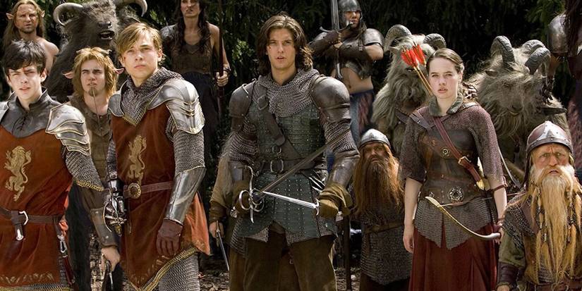 Prince Caspian and the Pevensie children standing together and wearing armor in Prince Caspian