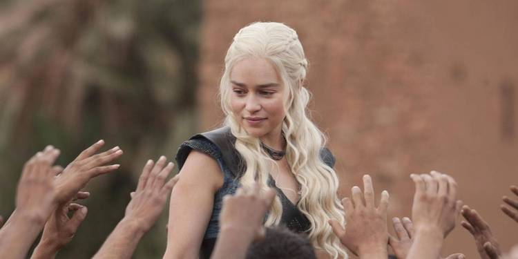 Daenerys Targaryen (Emilia Clarke) in a crowd of raised hands in Game of Thrones season 3, episode 10, "Mhysa"