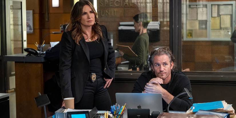 Benson standing next to Bruno's desk while they both look at something in the distance in Law & Order: SVU