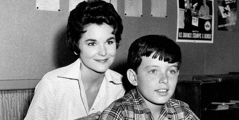 Miss Landers standing behind Beaver Cleaver