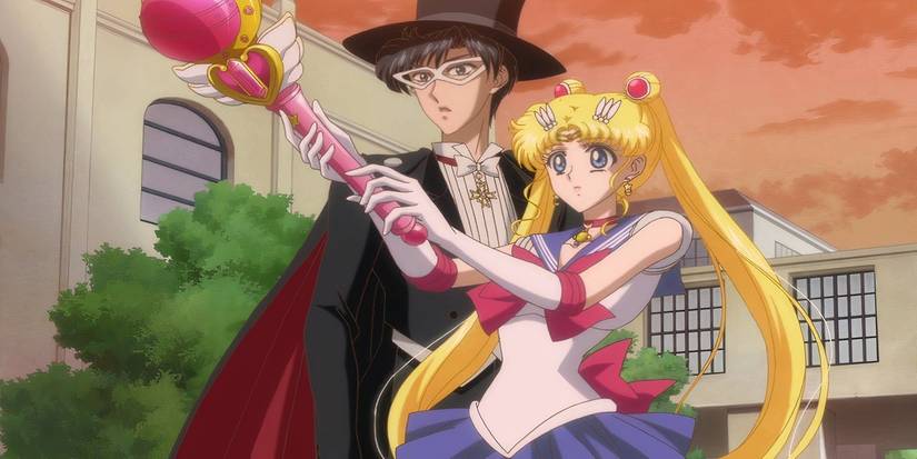 Sailor Moon wielding her staff as Tuxedo Mask looks surprised at dusk.