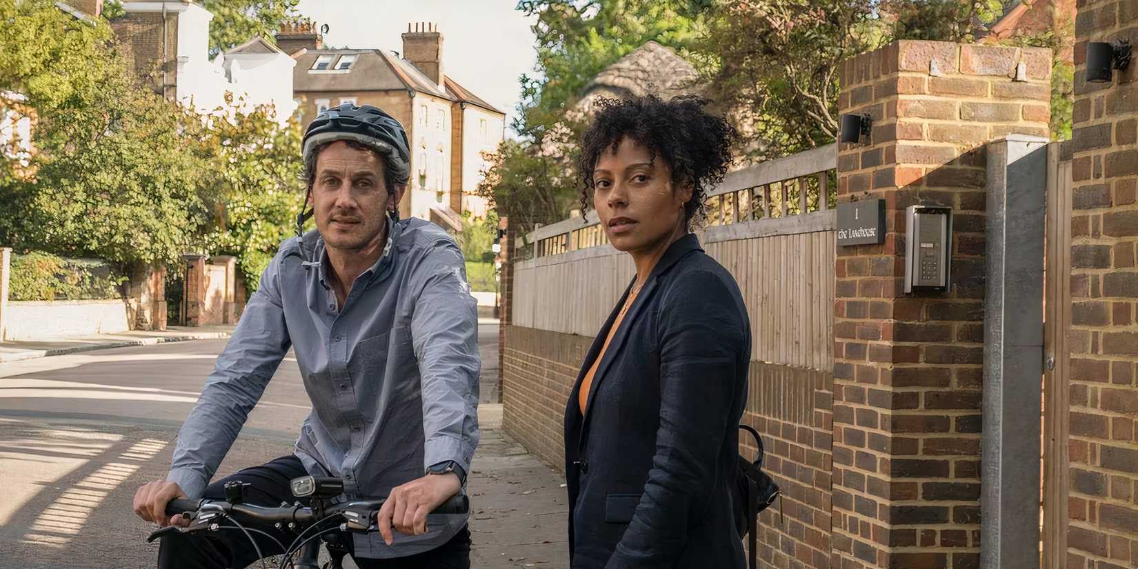 Min Harper (Dustin Demri-Burns) sits on a bicycle beside Louisa Guy (Sophie Eleazar) in Slow Horses.