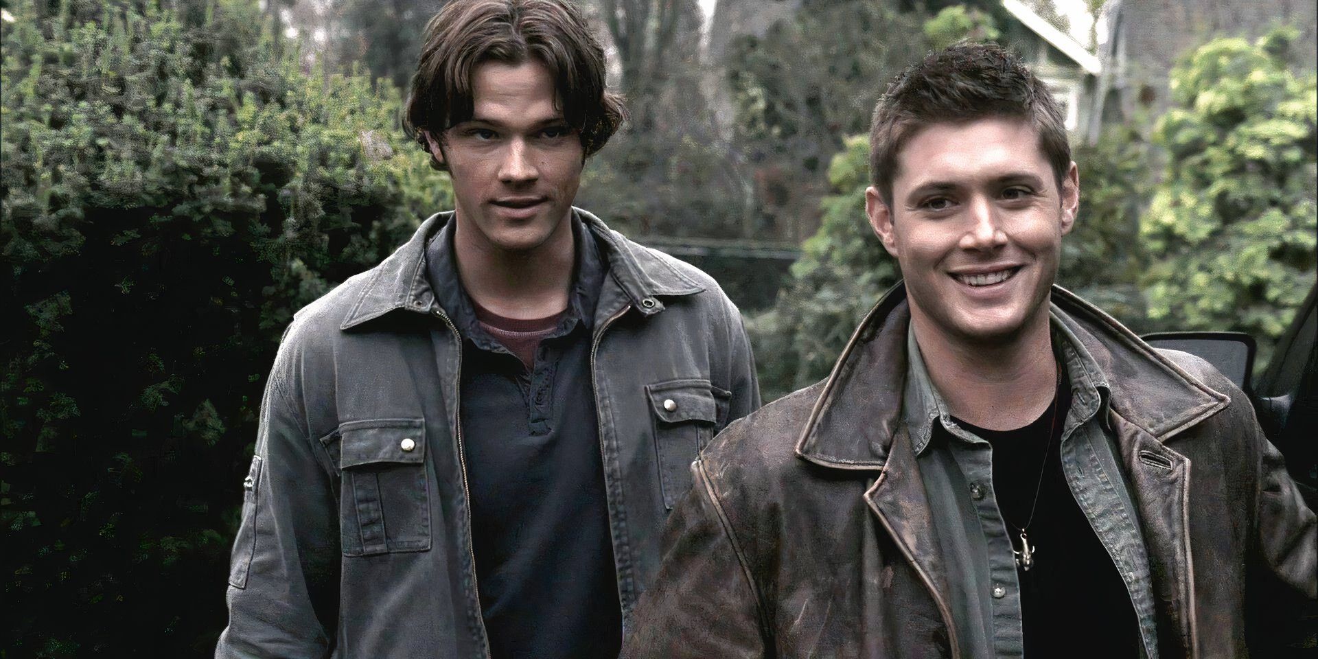 Sam and Dean smiling as they walk in Supernatural season 2.