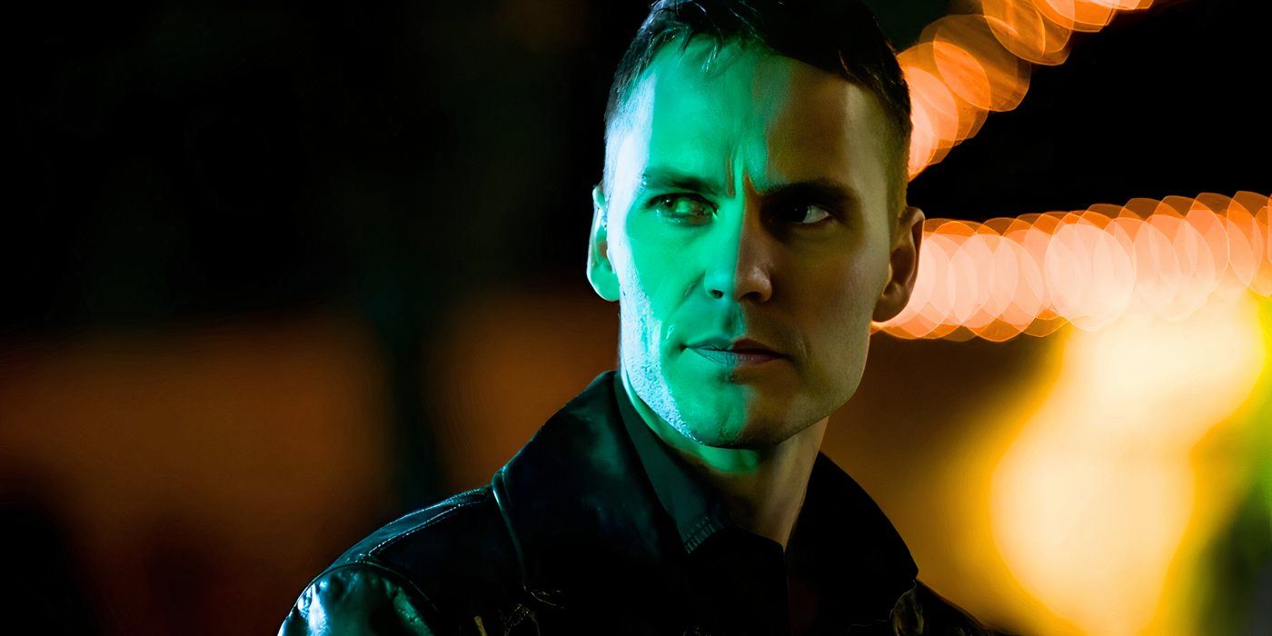 Taylor Kitsch lit by green neon light and looking serious in True Detective season 2 