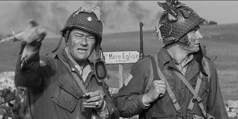JOhn Wayne as Lieutenant Col. Benjamin H. Vandervoort pointing at something in The Longest Day