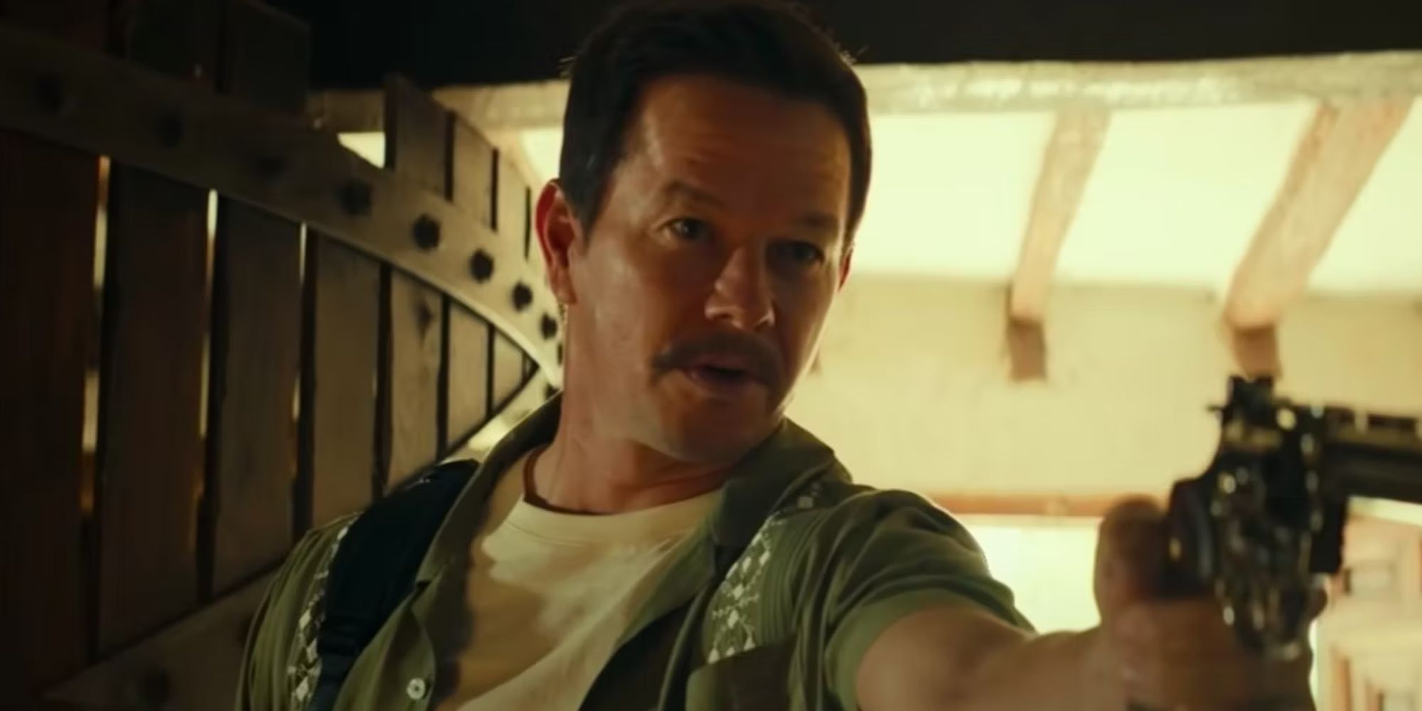 Mark Wahlberg as Sully aiming a gun in Uncharted