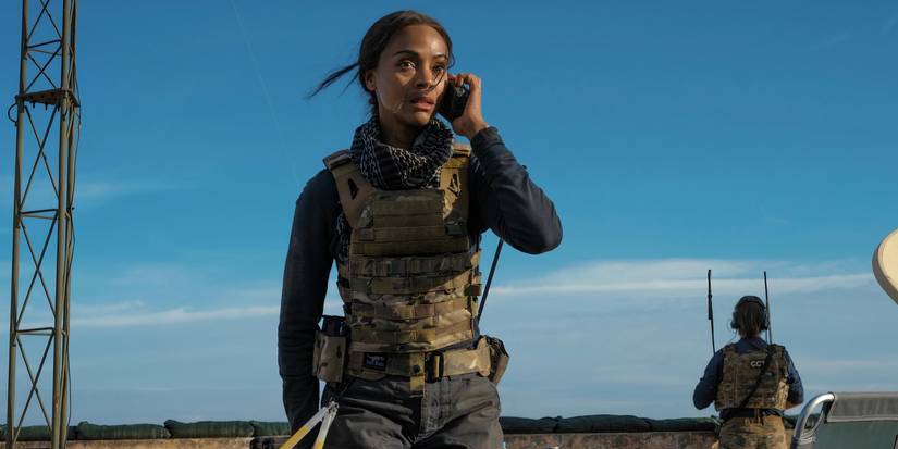 Zoe Saldaña talks on the phone in the field in Lioness season 1