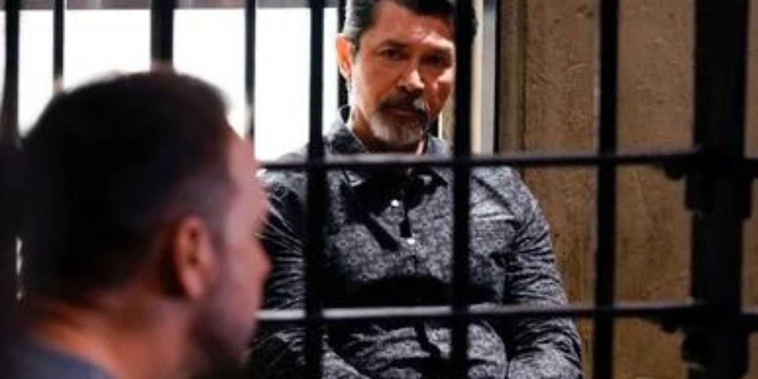 Blue Bloods Luis Delgado sitting in a cell facing Danny