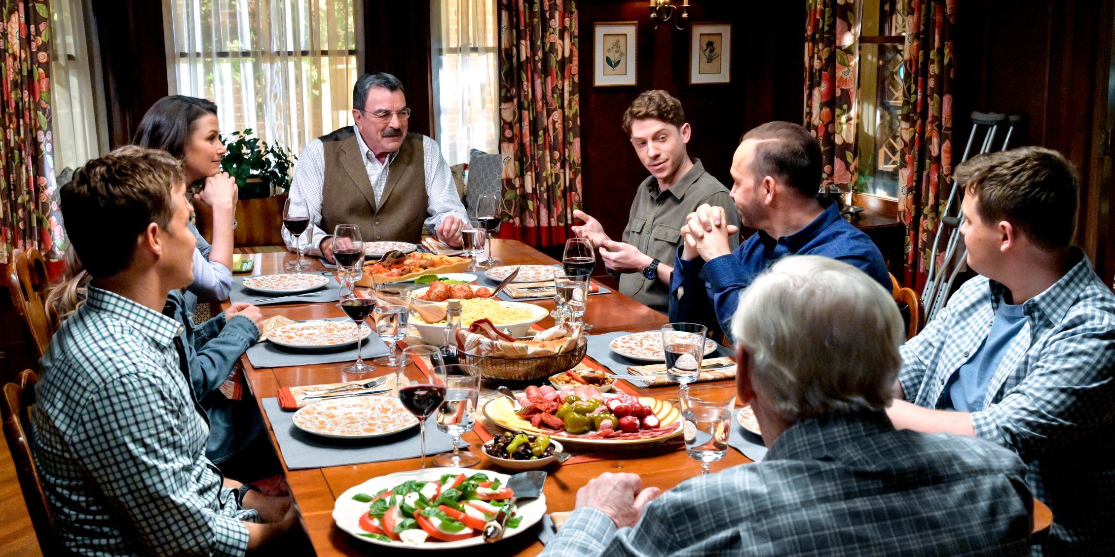 Blue Bloods Joe is on Frank's right making a point while the family gets ready to say Grace