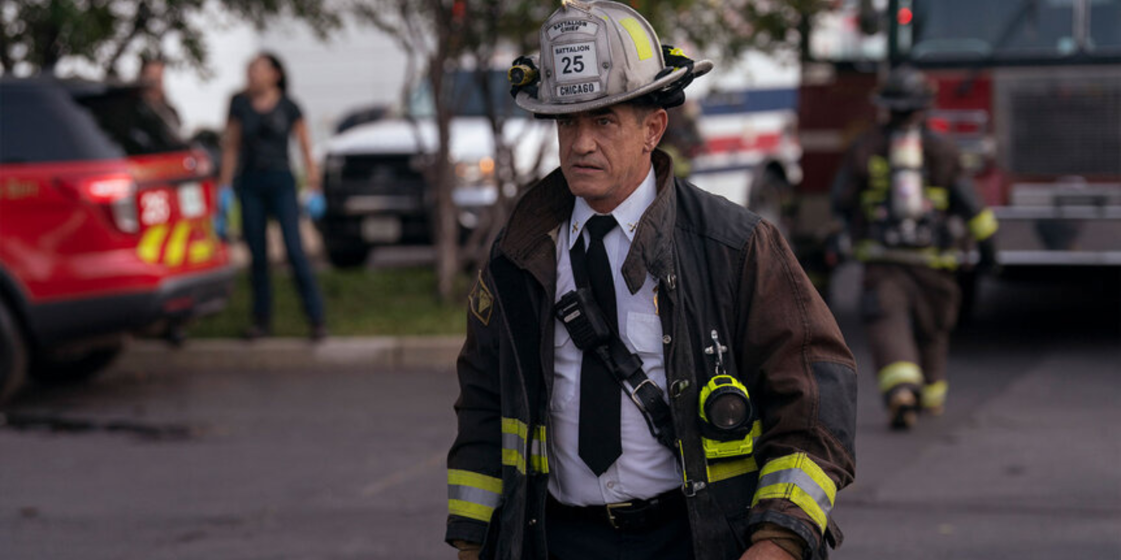 Chicago Fire Severide approaching a scene in fire gear and a tie