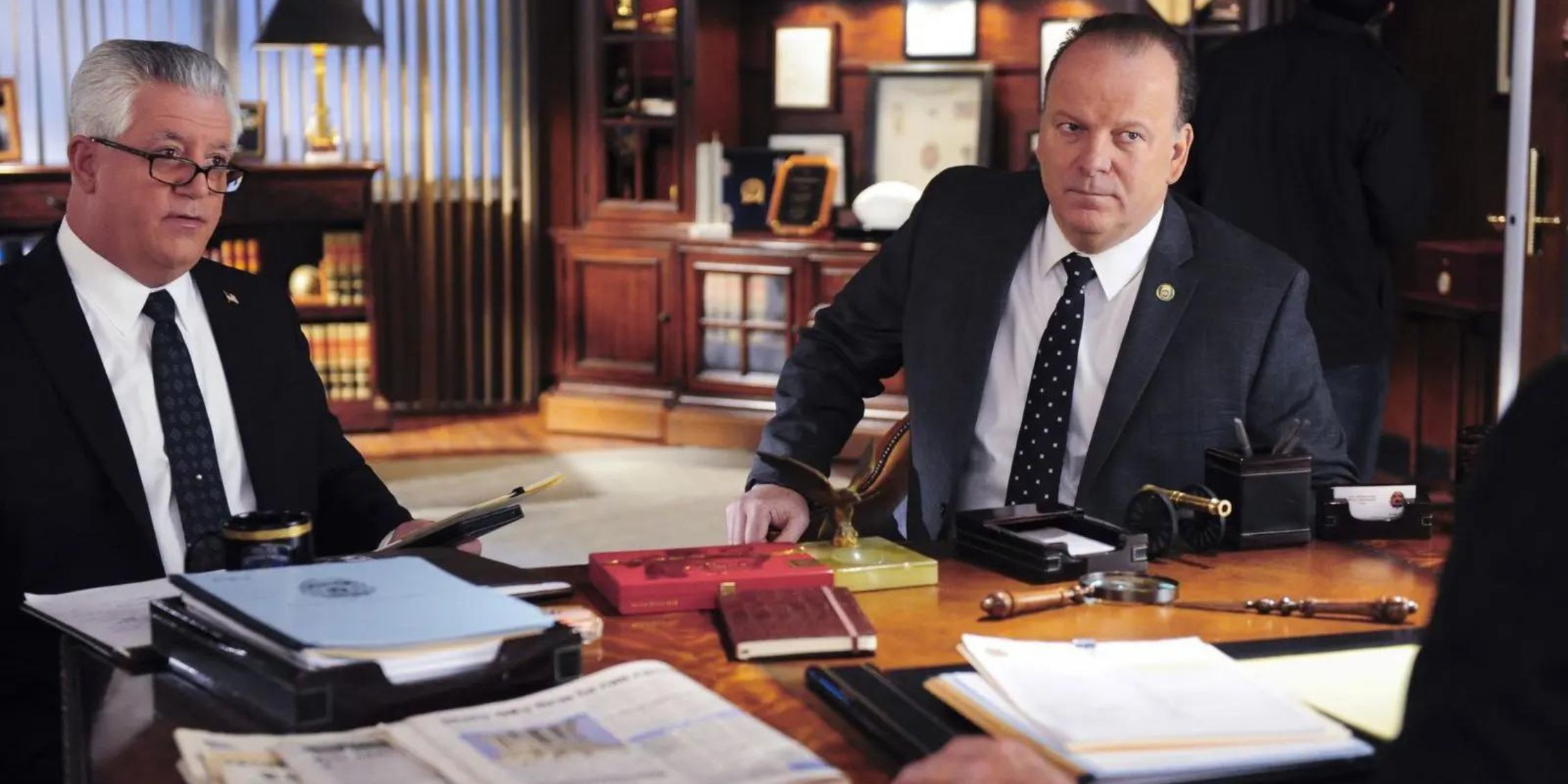 Blue Bloods Sid and Garrett sit across from Frank's desk listening to him