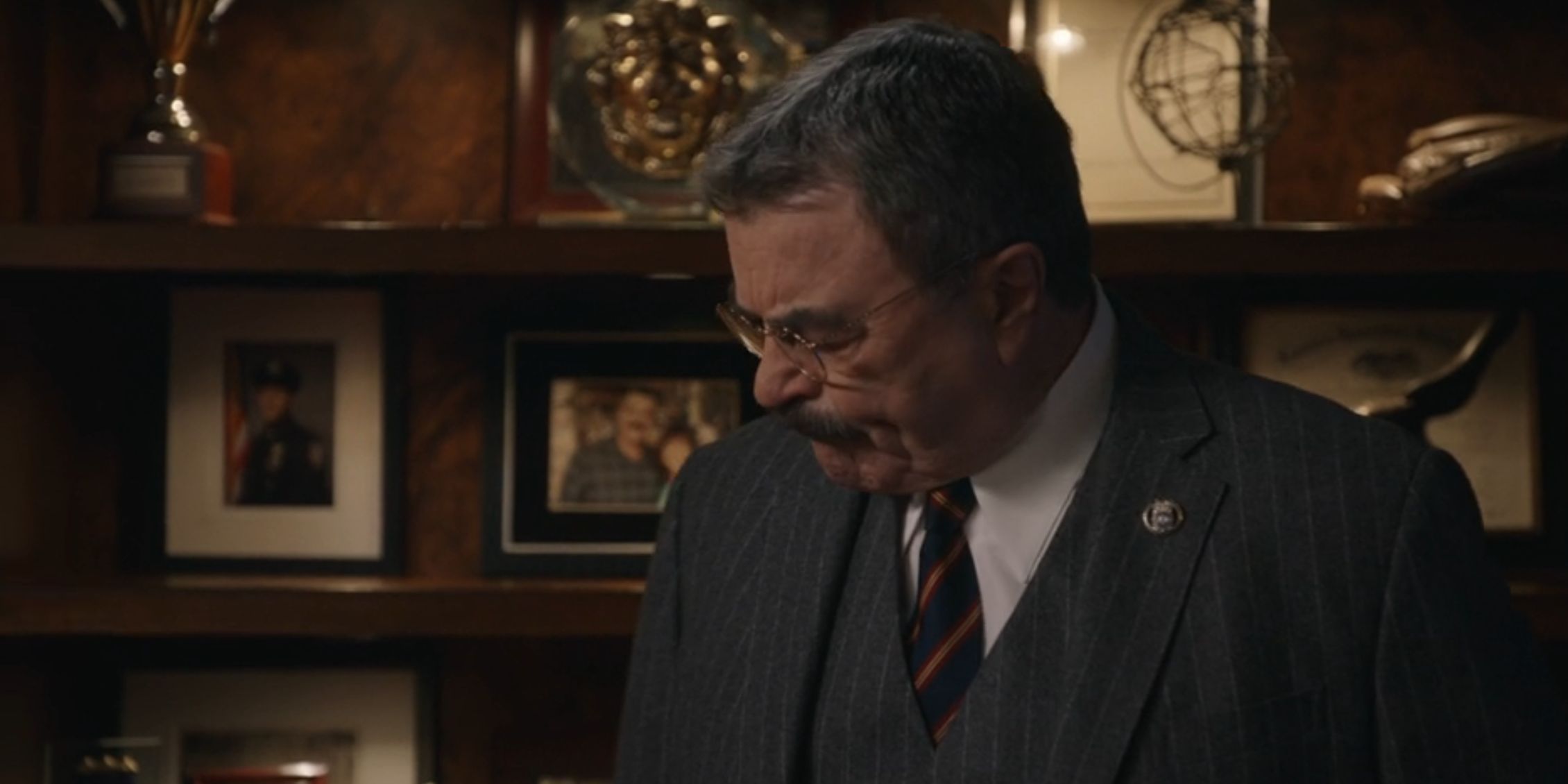 Blue Bloods Frank standing in his office with his head bowed