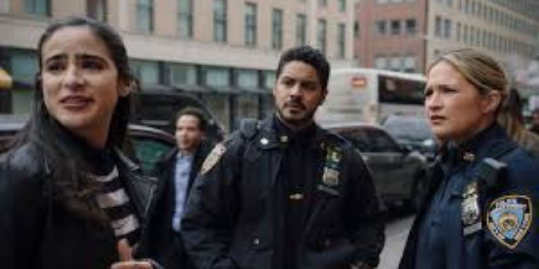 Blue Bloods Badillo And Eddie on a NYC street looking at someone off-screen