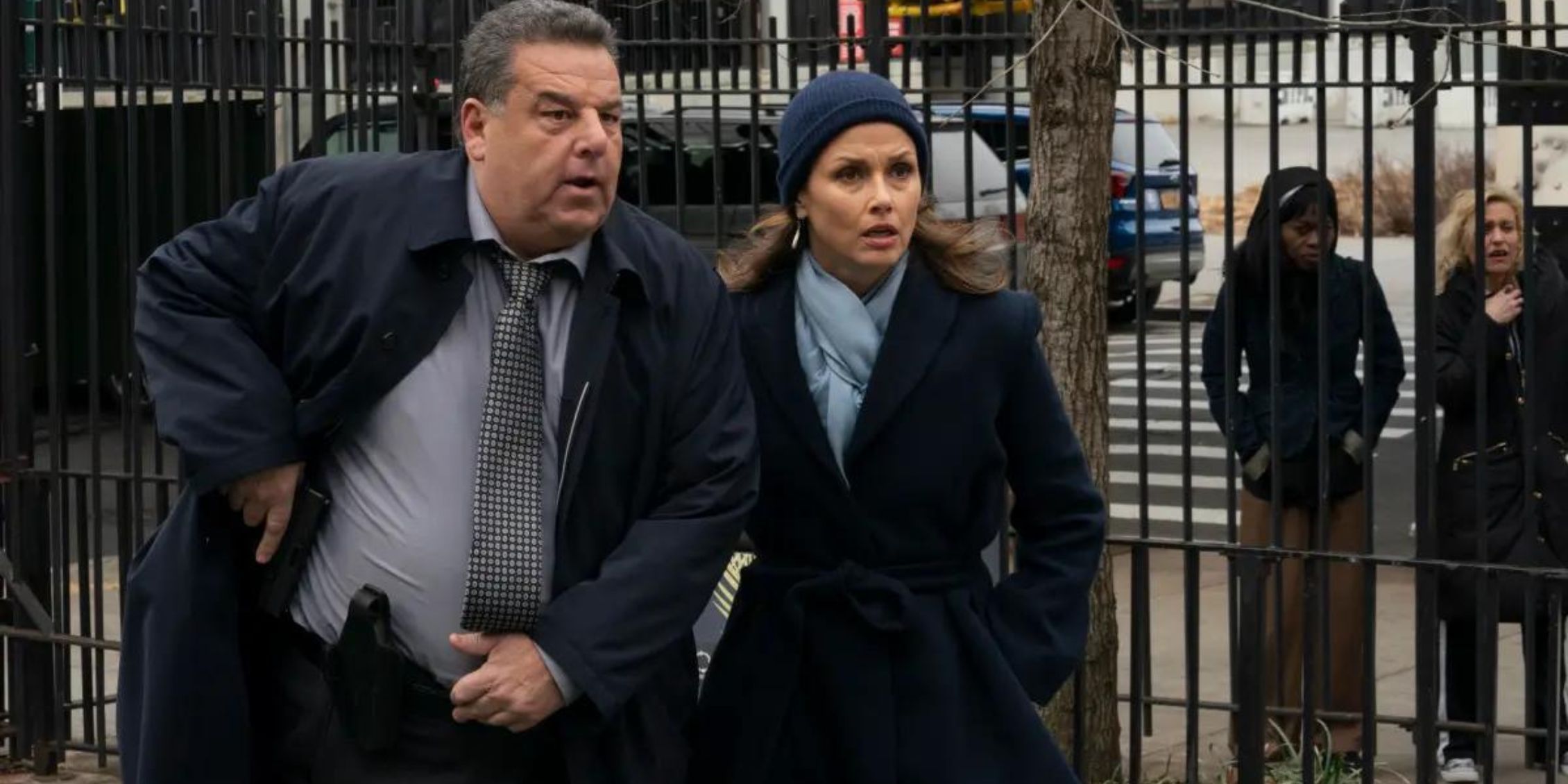 Blue Bloods Anthony standing next to Erin and holding his gun near its holster