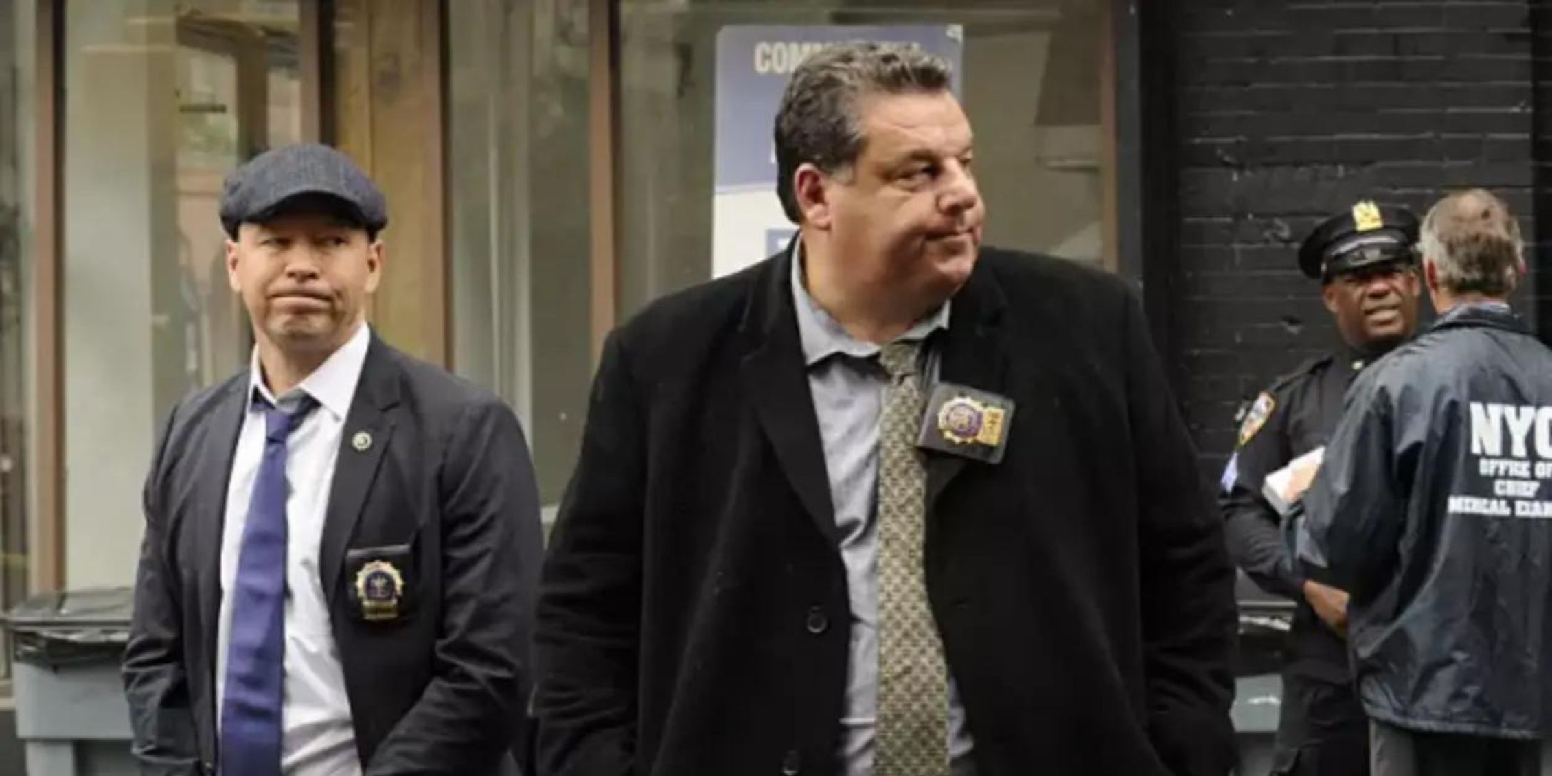 Blue Bloods Anthony stands in front of Danny looking at something off-screen