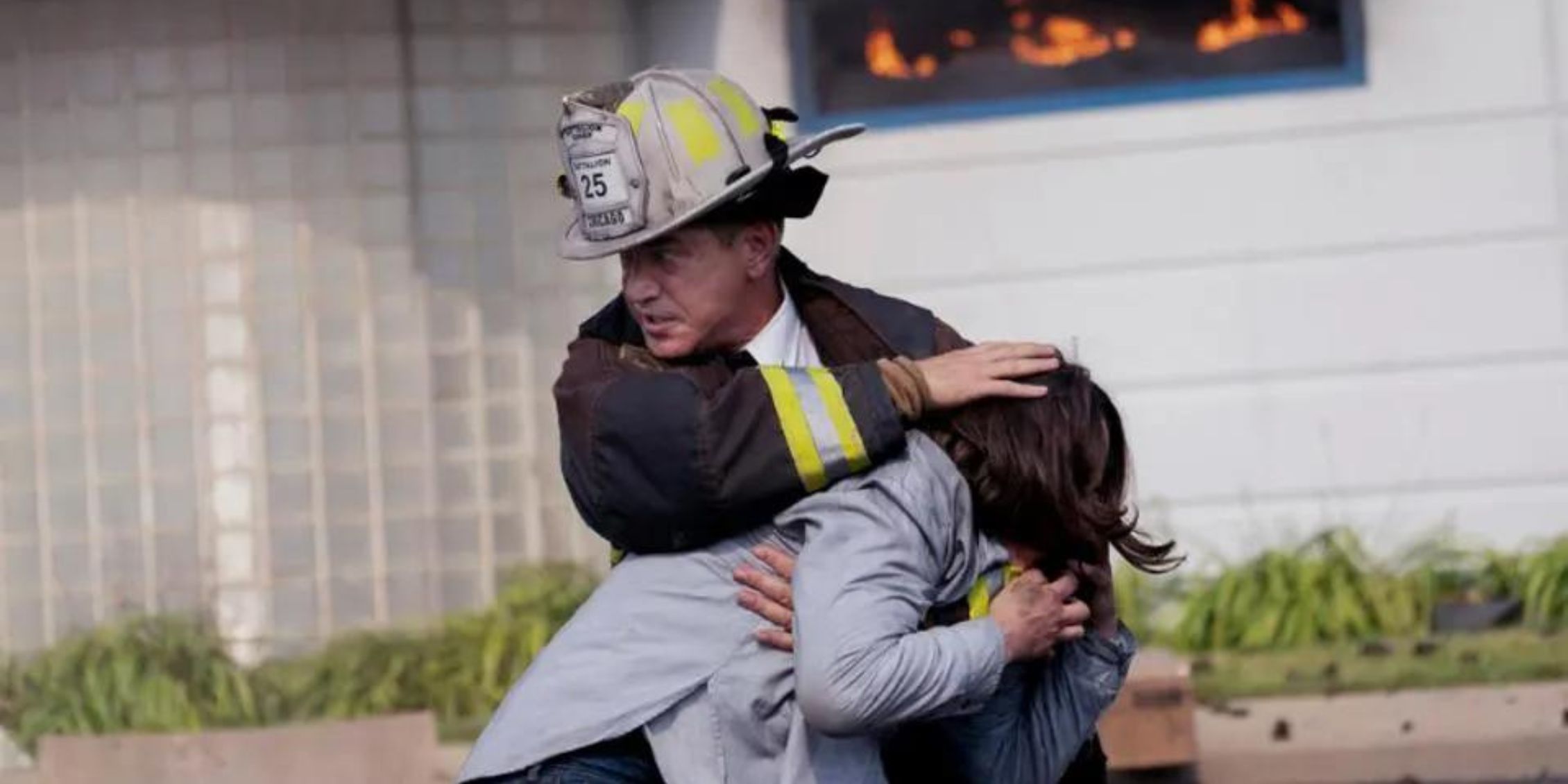 Chicago Fire Pascal carrying a young woman away from a fire