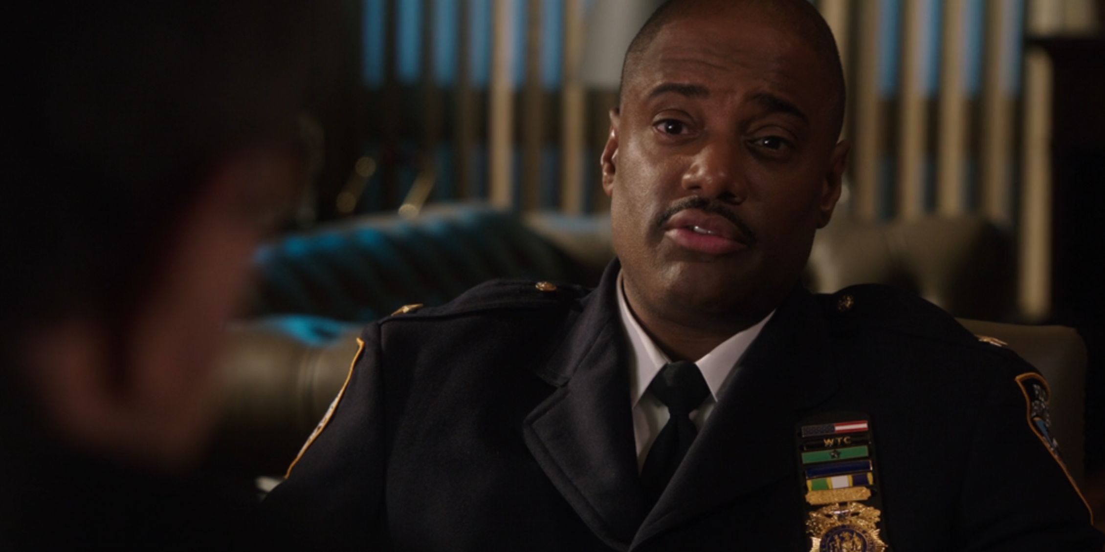 Blue Bloods A Black cop in uniform sitting across from Frank