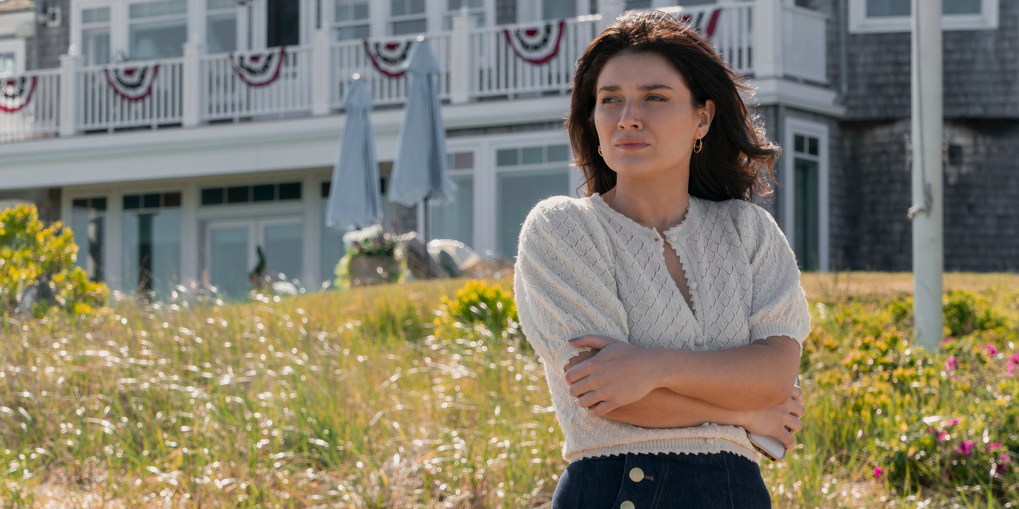 Amelia stands outside the house crossing her arms in The Perfect Couple episode 6